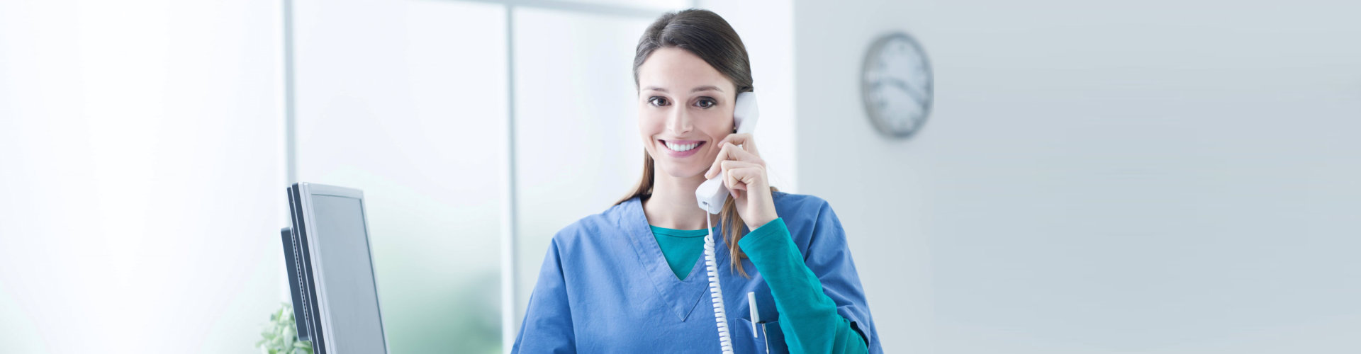 caregiver answering phone call smiling